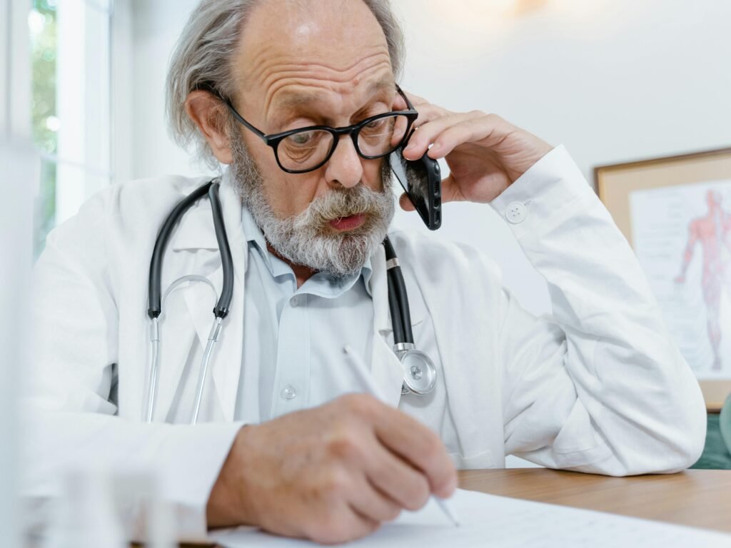 Doctor on call and writing notes – Telemedicine Marketing Strategies 2025 for clinics to grow online