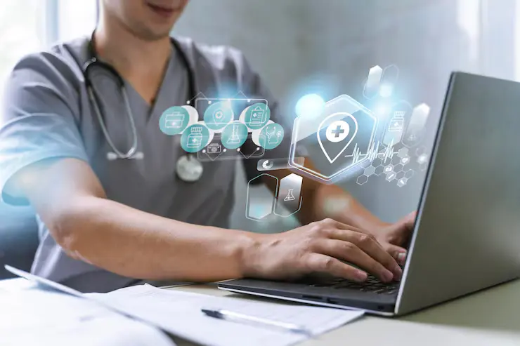 Doctor creating digital content on laptop as part of a healthcare marketing strategy